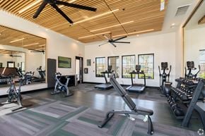 Bakersfield apartment for rent - A gym with a variety of equipment including treadmills, stationary bikes, and weight machines.