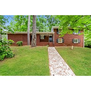 Morrow house for rent - a brick house with a lawn and trees
