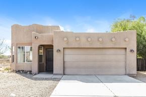 Vail house for rent - A house with a garage door and a black door.
