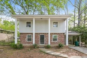 Forest Park house for rent - A white house with a brick front and a black door.