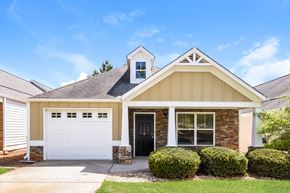 Cartersville house for rent - A house with a white garage door and a black door.