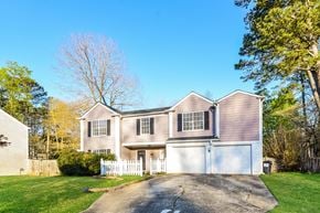 Kennesaw house for rent - A two-story house with a white garage door.