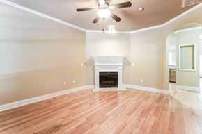 Stone Mountain house for rent - an empty living room with a fireplace and a ceiling fan