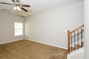 Woodstock townhouse for rent - A room with a ceiling fan and carpeted floor.