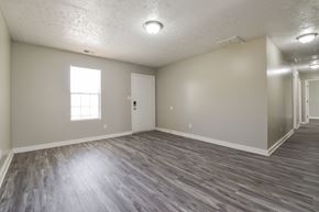 Conley house for rent - A room with wooden flooring and a window.