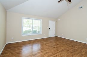 Cartersville house for rent - Empty room with wooden floors and a window.