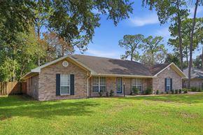 Jacksonville house for rent - A house with a brown roof and a green lawn in front.