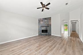 Atlantic Beach house for rent - A room with a fireplace and a ceiling fan.