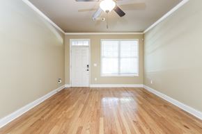 Stone Mountain house for rent - an empty living room with wooden floors and a ceiling fan