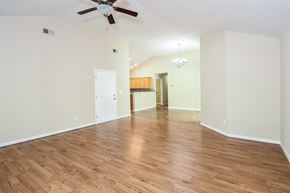 Cartersville house for rent - A room with a ceiling fan and wooden flooring.