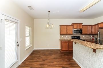 Woodstock house for rent - a kitchen with wood flooring and a granite counter top