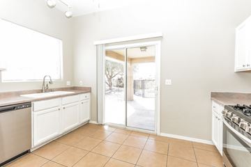 Vail house for rent - A kitchen with white cabinets and a tiled floor.