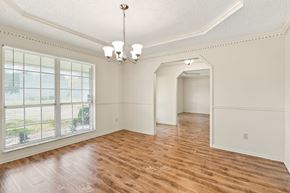 Jacksonville house for rent - A room with wooden floors and a chandelier.
