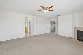 Lancaster house for rent - A living room with a fireplace and a ceiling fan.