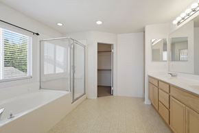 Lancaster house for rent - A bathroom with a large tub and a walk-in shower.