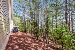 Cartersville house for rent - A backyard with a shed and trees.