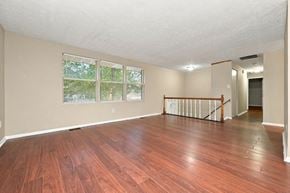 Lithonia house for rent - A room with wooden floors and a window overlooking a green area.