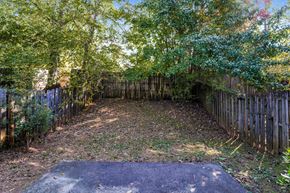 Stone Mountain house for rent - a backyard with a wooden fence and trees