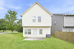 Fairburn house for rent - A white house with a grey roof and a wooden fence in front.