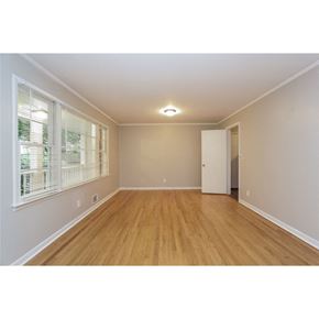 College Park house for rent - a spacious living room with wood floors and a large window
