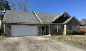 Adairsville house for rent - A house with a grey roof and a white garage door.