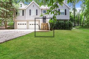 Hiram house for rent - A house with a grey facade and a white garage door.