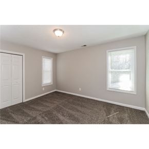 Marietta house for rent - an empty bedroom with two windows and a door