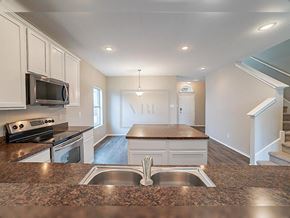 Forney house for rent - A kitchen with granite countertops and stainless steel appliances.