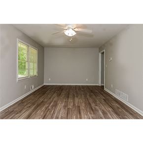 Morrow house for rent - an empty living room with wood floors and a ceiling fan