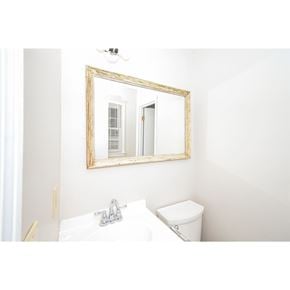 Hiram house for rent - A bathroom with a toilet, sink, mirror, and light fixture.