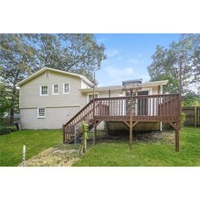 Hiram house for rent - A house with a deck and a tree in front.