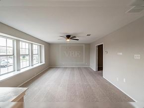 Forney house for rent - A room with a carpeted floor and a ceiling fan.