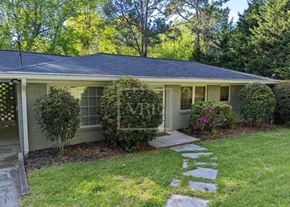 Roswell house for rent - A house with a well-maintained lawn and a stone pathway leading to the front door.