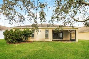 Brooksville house for rent - A house with a green lawn and trees in front.