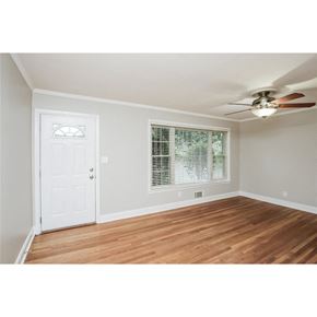 Roswell house for rent - A room with a white door and a window with blinds.