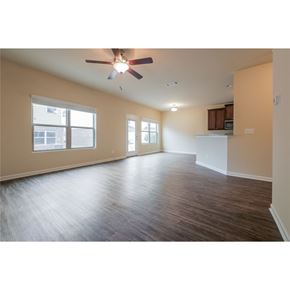 Mcdonough house for rent - A room with a ceiling fan and wooden flooring.