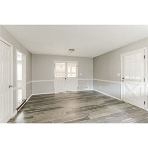 Stone Mountain house for rent - a spacious living room with white doors and wood floors