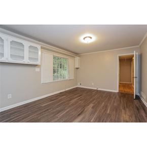 College Park house for rent - an empty living room with a door to a hallway