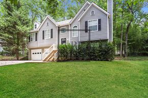 Hiram house for rent - A house with a grey exterior and a white garage door.