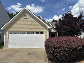 Cartersville house for rent - the front of a house with a white garage door
