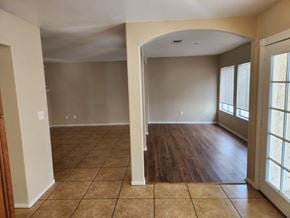 Las Vegas house for rent - A room with a tiled floor and a large arched doorway.