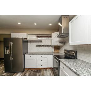 Temple house for rent - a kitchen with white cabinets and a stainless steel refrigerator