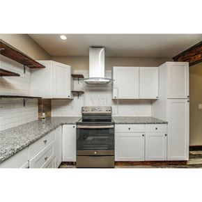 Temple house for rent - a kitchen with white cabinets and a stove and a sink