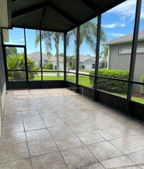 Lakeland house for rent - a screened in porch with a view of the grass