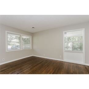 Fairburn house for rent - A room with wooden floors and two windows.