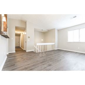 Stone Mountain house for rent - an empty living room with wood floors and a staircase