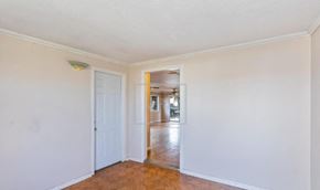 Elverta house for rent - an empty living room with white walls and a door to a hallway