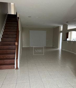Lakeland house for rent - a living room with a staircase and a tile floor