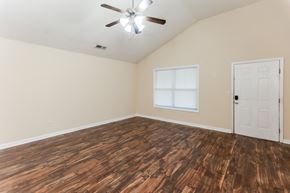 Cartersville house for rent - A room with a ceiling fan and wooden flooring.