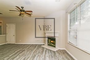 Lithonia house for rent - A room with a fireplace and a VRE sign on the wall.